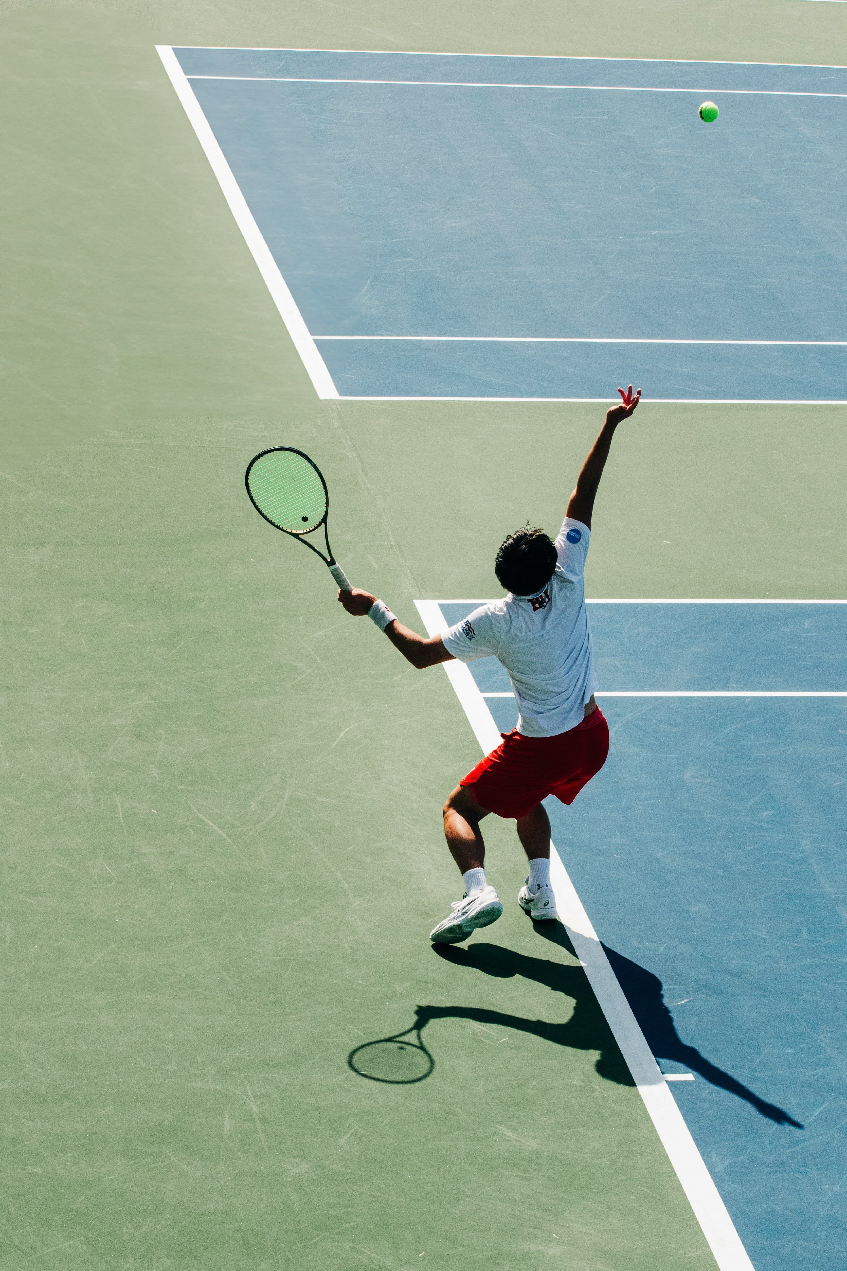 Friends playing pickleball on bright outdoor courts